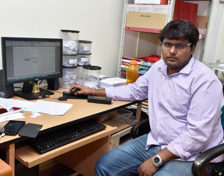 A man sitting at a desk with a computer.