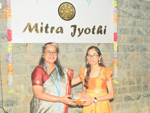 Student reciving gift on 56th Digital Literacy Batch - Valedictory Function at Mitra Jyothi.